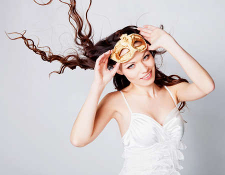 Beautiful brunette girl in masquerade maskの写真素材