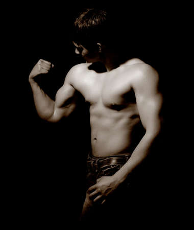 Low key image of young fitness man の写真素材