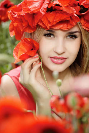 beautiful blonde in a poppy wreathの写真素材