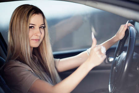 Beautiful blond girl in her carの写真素材