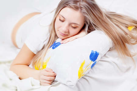 Young beautiful girl sleeping on the pillowの写真素材