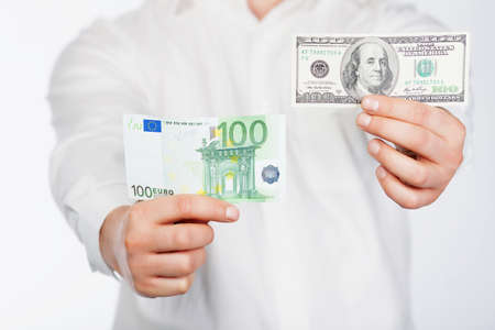 Man with dollar and euro banknote in handsの写真素材