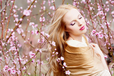 Beautiful young woman in peach gardenの写真素材