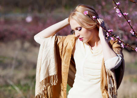 Beautiful young woman in peach gardenの写真素材