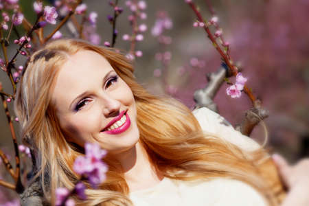 Beautiful young woman in peach gardenの写真素材