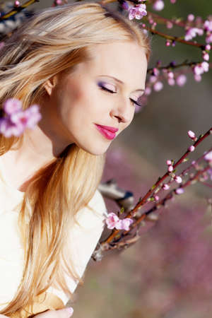 Beautiful young woman in peach gardenの写真素材