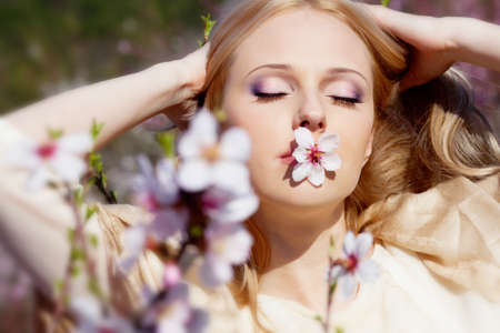 Beautiful young woman in peach gardenの写真素材
