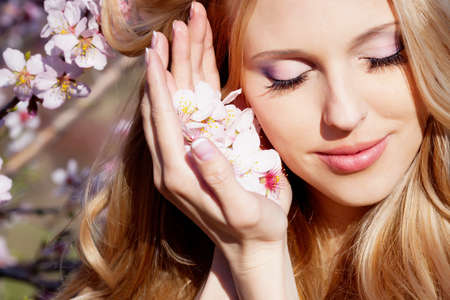 Beautiful young woman in peach gardenの写真素材