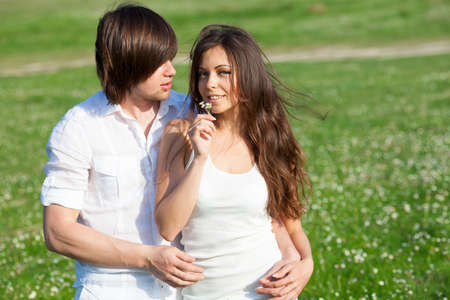 Two lovers on the grass meadowの写真素材