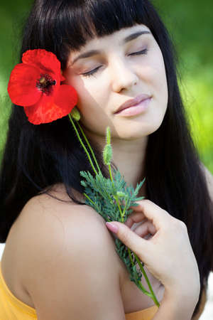 Girl portrait with poppy flowerの写真素材
