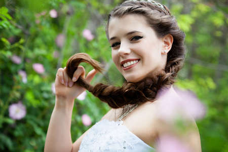 Beautiful brunette bride portrait in summer parkの写真素材