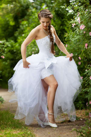 Beautiful brunette bride portrait in summer parkの写真素材