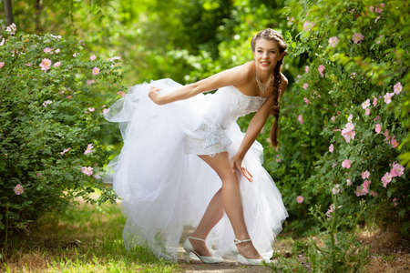 Beautiful brunette bride portrait in summer parkの写真素材