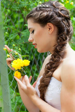 Beautiful brunette bride portrait in summer parkの写真素材