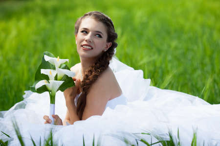 Beautiful brunette bride portrait in summer parkの写真素材