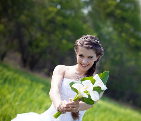 Beautiful brunette bride portrait in summer parkの写真素材