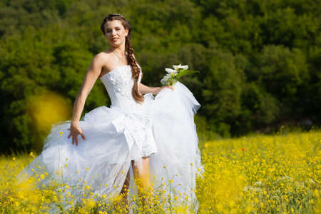 Beautiful brunette bride portrait in summer parkの写真素材