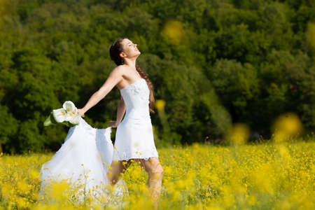 Beautiful brunette bride portrait in summer parkの写真素材
