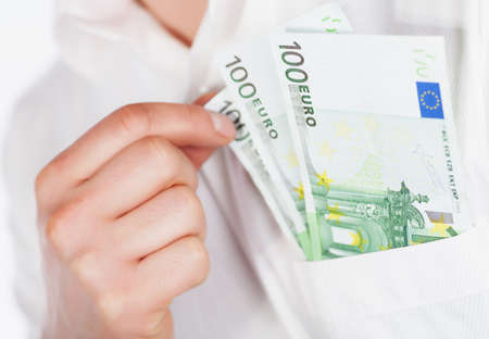 Man holding euro currency in pocketの写真素材