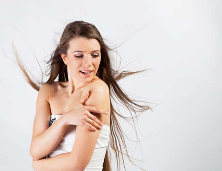 Beautiful brunette girl with healthy hair in studioの写真素材