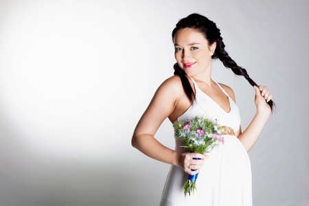 Beautiful pregnant woman in studioの写真素材