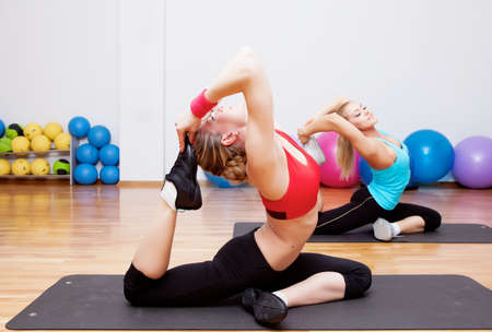 Two girls training in fitness clubの写真素材
