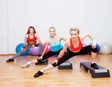 Three girls training in fitness clubの写真素材