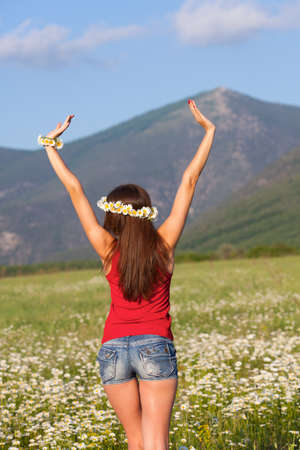 Girl in wreath on camomile meadowの写真素材