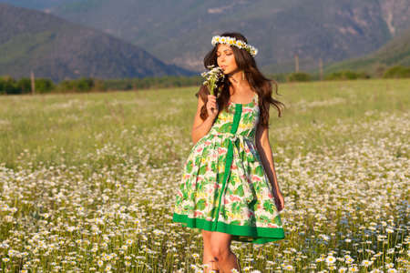 Girl in wreath on camomile meadowの写真素材