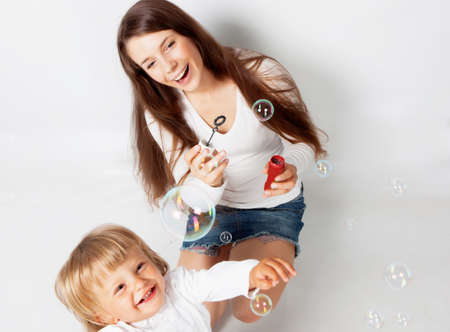 Mother playing with son in studioの写真素材