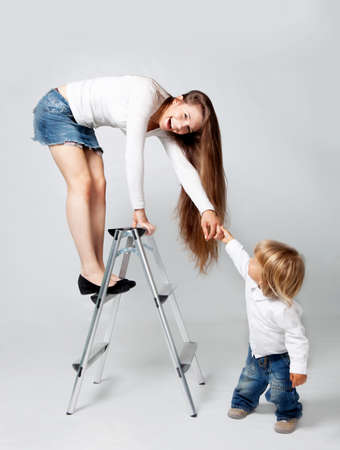 Mother playing with son in studioの写真素材
