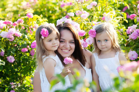 Family playing in the rose flowers gardenの写真素材