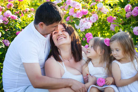 Family playing in the rose flowers gardenの写真素材