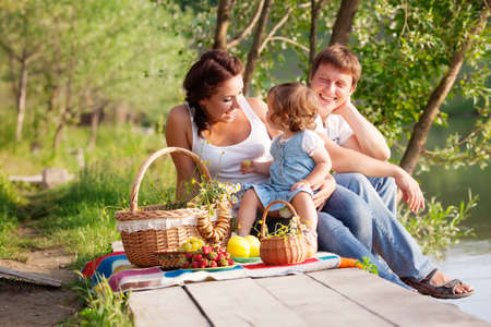 Family on picnic near the lakeの写真素材