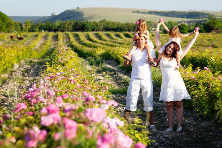 Family in rose flowers gardenの写真素材