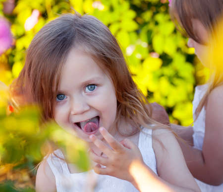 Girl playing in rose gardenの写真素材