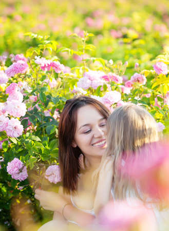 Mother with daughter in rose flowers gardenの写真素材