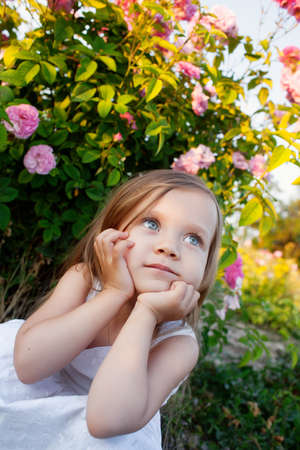 Girl playing in rose gardenの写真素材