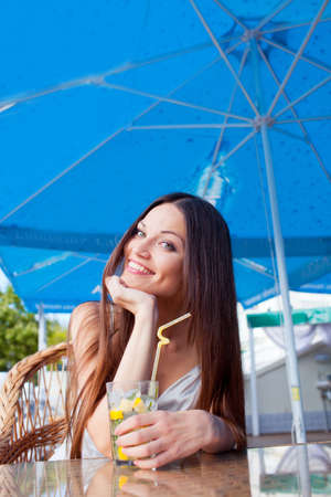Beautiful girl with mojito drink in cafeの写真素材
