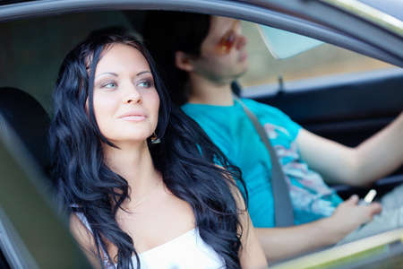 Young beautiful woman with driver in the carの写真素材