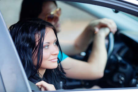 Young beautiful woman with driver in the carの写真素材