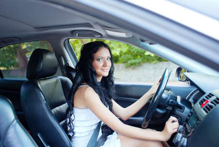 Young beautiful woman driving the carの写真素材