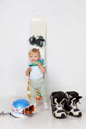 Little girl with snowboard in studioの写真素材