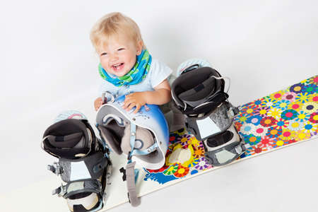 Little girl with snowboard in studioの写真素材