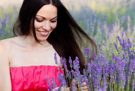 Beautiful long-haired brunette in a lavender fieldの写真素材