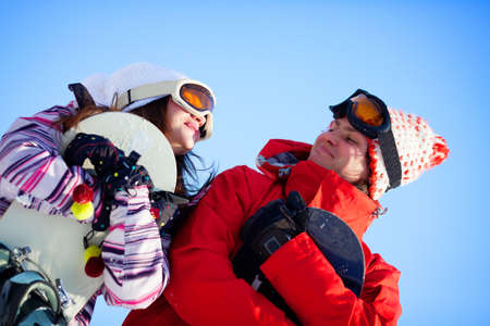 Girl and boy with snowboardsの写真素材