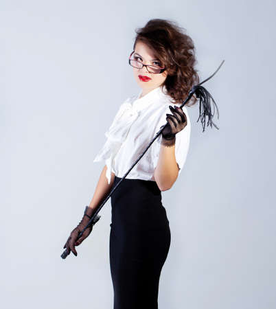 Strict teacher with glasses and a whipの写真素材