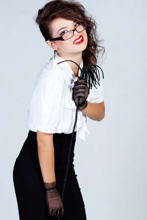 Strict  teacher with glasses and a whipの写真素材