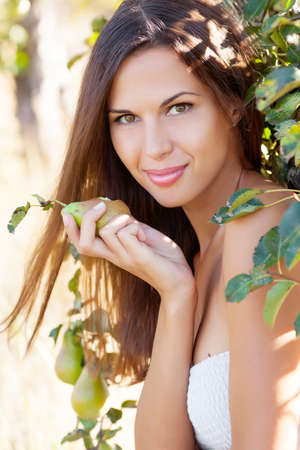 Beautiful woman in pear gardenの写真素材