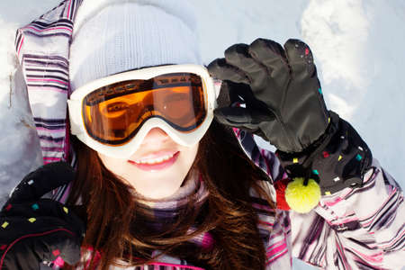 Beautiful girl in winter forest with snowboardの写真素材